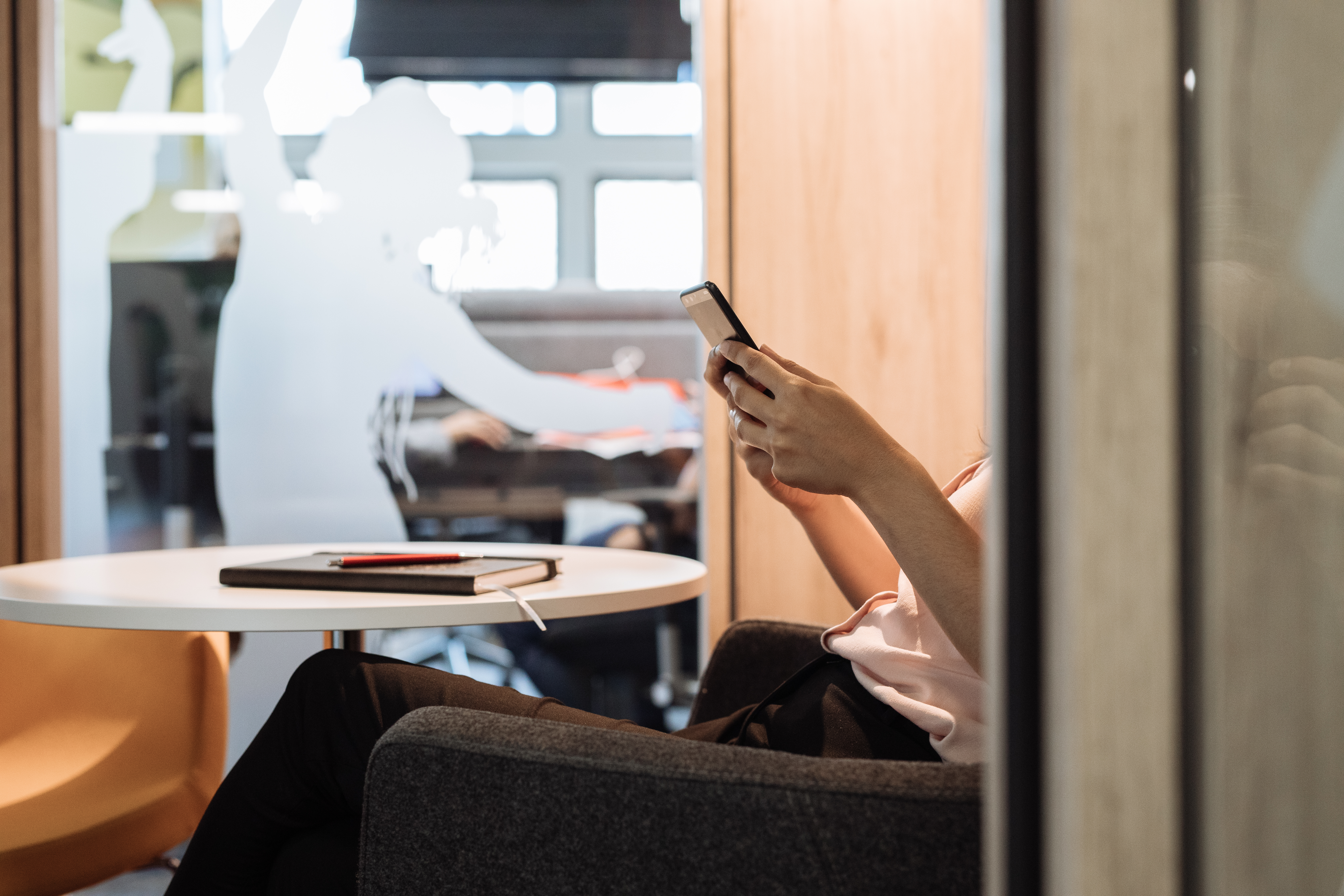 Change woman with smartphone in chair